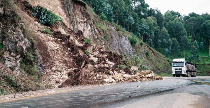 Debris partially covers a road following a landslide after heavy rain in Rubengera, Rwanda, on May 3, 2023. At least 127 people have died as floods and landslides engulfed several parts of Rwanda after torrential rains, destroying homes and cutting off roads, the presidency said Wednesday. AFPPIX