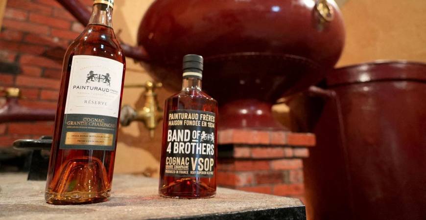 Bottles of Cognac and a still are seen in the Painturaud Freres wine cellar in Segonzac, France, October 9, 2024. - REUTERSPIX