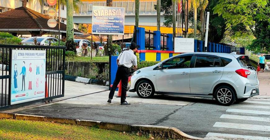 Security presence at the school yesterday as the community grapples with the tragedy that claimed a student’s life. – ADIB RAWI YAHYA/THESUN