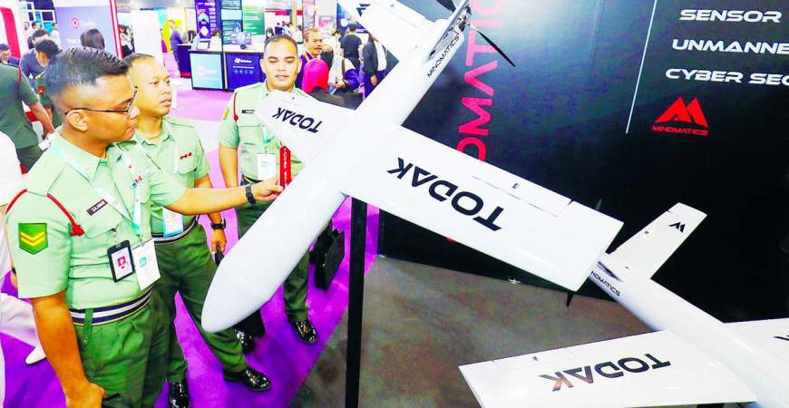 Army personnel examine a bomber drone developed by a local defence tech company during the event. – Adib Rawi Yahya/theSun