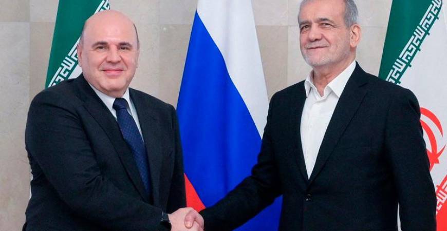 In this pool photograph distributed by the Russian state agency Sputnik, Russia's Prime Minister Mikhail Mishustin meets with Iran's President Masoud Pezeshkian in Moscow on January 17, 2025. (Photo by Alexander ASTAFYEV / POOL / AFP)