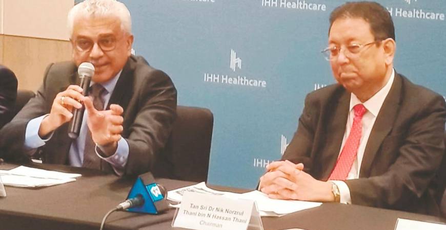 Dr Prem (left) with IHH Healthcare chairman Tan Sri Dr Nik Norzrul Thani N Hassan Thani at a press conference after the company’s annual general meeting yesterday.