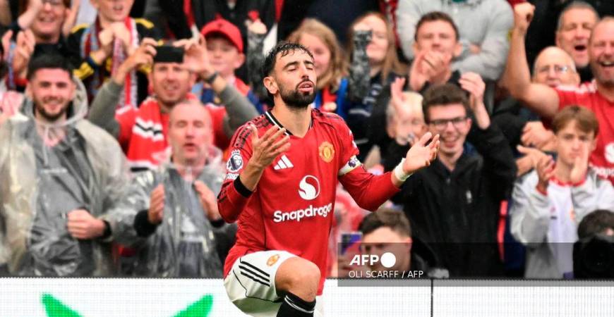 Manchester United's Portuguese midfielder #08 Bruno Fernandes celebrates scoring their third goal from the penalty spot during the English Premier League football match between Manchester United and Burnley at Old Trafford in Manchester, north west England, on August 30, 2025. - AFP