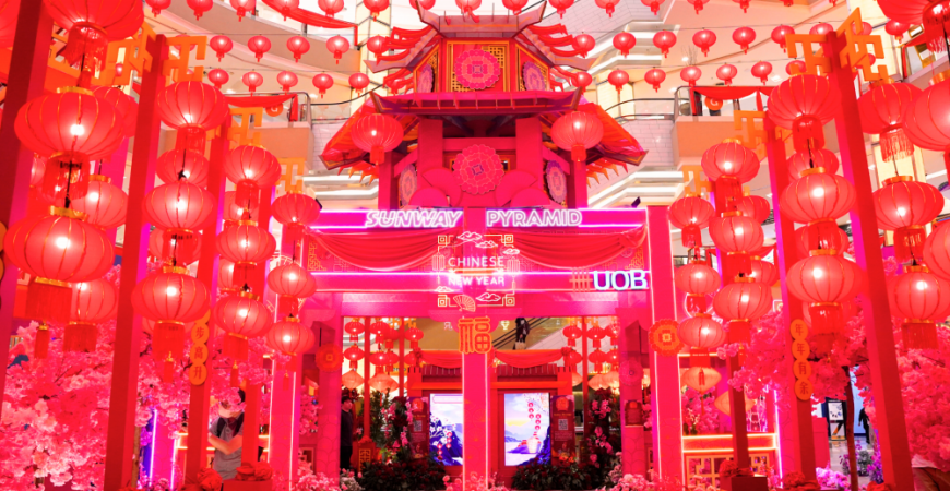 Sunway Pyramid’s decorations combine oriental structures, vibrant blossoms and glowing lanterns.