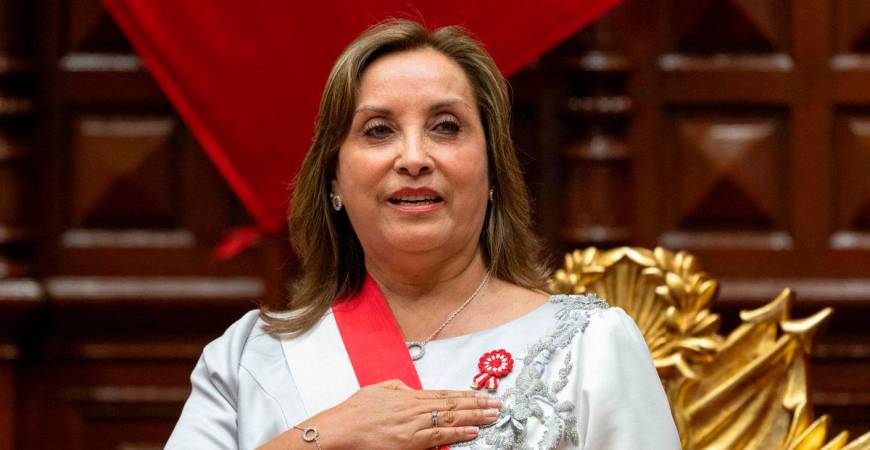 (FILES) Peruvian President Dina Boluarte gestures upon her arrival to deliver her address to the nation on Independence Day at the National Congress in Lima on July 28, 2024. (Photo by Cris BOURONCLE / POOL / AFP)