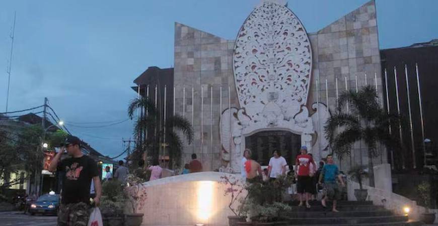 A tourist crosses the street from the Ground Zero Monument in Kuta, Bali - REUTERSpix