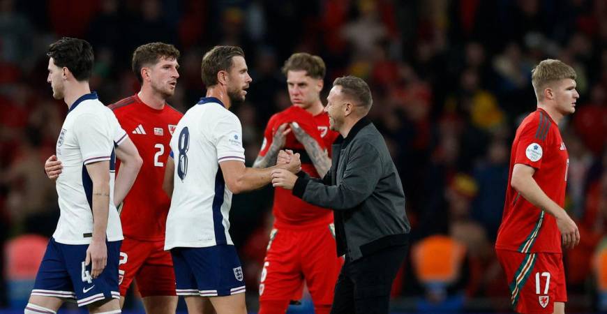 England’s Jordan Henderson shakes hands with Wales manager Craig Bellamy after the match Action Images via Reuters/Peter Cziborra