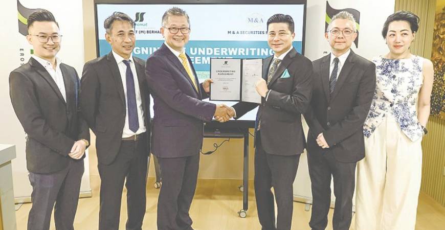 Ng (third from left) and M&amp;A Equity Holdings managing director Datuk Bill Tan, representing M&amp;A Securities, displaying the signed documents.