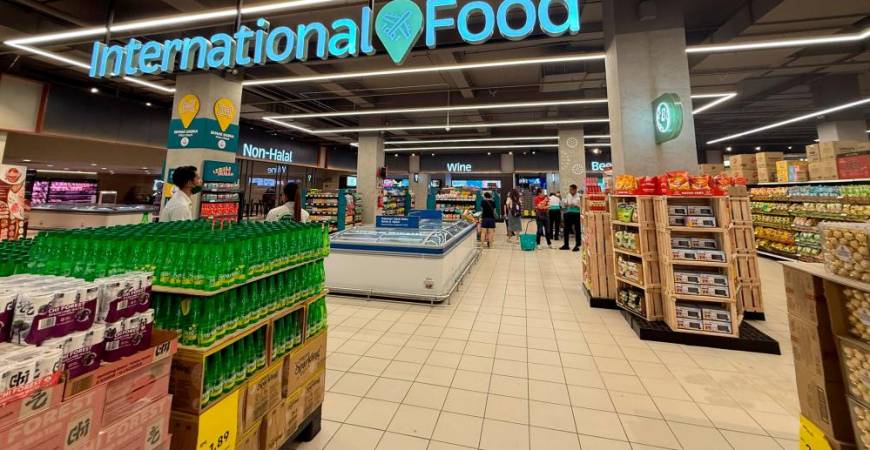 Customers shopping for groceries, sampling on food items at the redefined Lotus’s Paradigm that offers more than 14,000 products in store, with clear zoning and signages, and new offerings that cater to those who are also looking for premium selections.