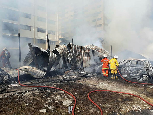 Firefighters at work at the scene of the fire in Bangsar.
