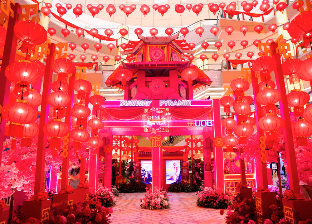 Sunway Pyramid’s decorations combine oriental structures, vibrant blossoms and glowing lanterns.