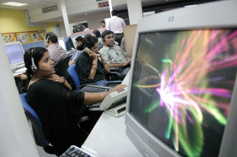 Workers in a call center in India: in 2016 US authorities charged five such call centers with operating fraud schemes targetting South Asians living in the United States. — AFP
