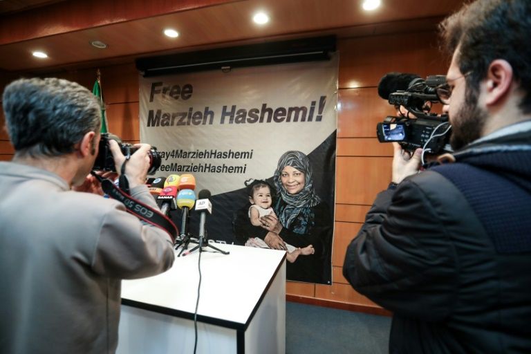 Journalists in Tehran photograph and film a poster calling for the release of Marzieh Hashemi, a US-born presenter for Iran’s Press TV who was arrested on a visit to her birth country. — AFP