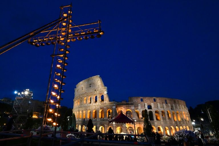 A cross lit with candles in front of the Coliseum in Rome ahead of the Way of the Cross procession. — AFP