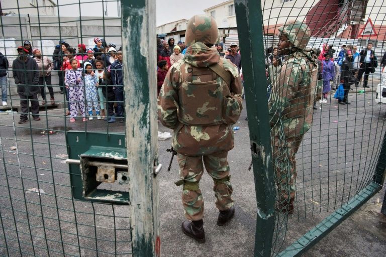 South African National Defense Force troops patrol a Cape Town street in one of the areas ravaged by gang violence. — AFP