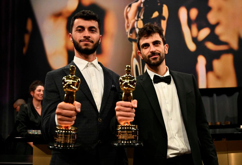 Adra (left) and Abraham wins the Academy Award for Best Documentary (Feature). – AFPPIC
