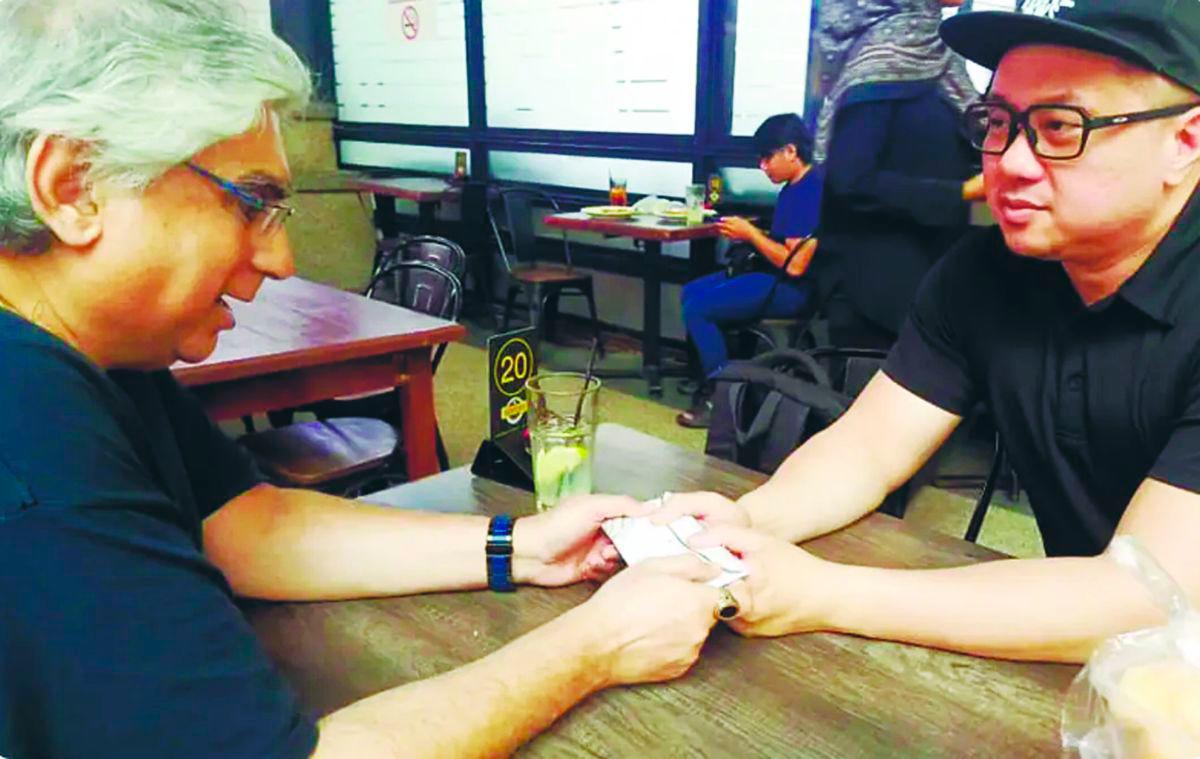 Danny (left) handing over cash to cancer-stricken Chong after the fundraiser last week. – PIC COURTESY OF ICE