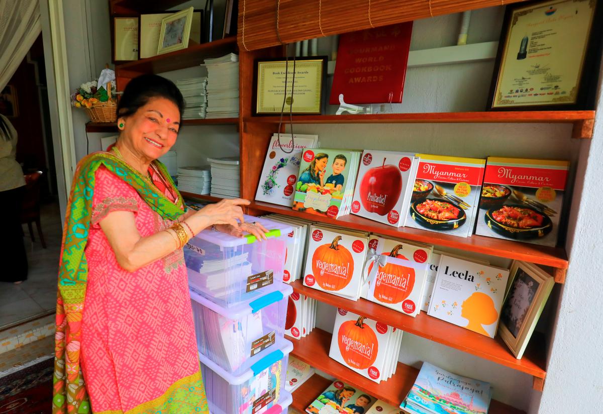 Mohana strikes a proud pose with her collection of books. $!Mohana strikes a proud pose with her collection of books.