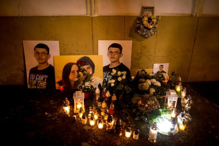 A picture taken in Bratislava on February 20, 2019 shows candles beside portraits of Slovakian journalist Jan Kuciak and his fiancee Martina Kusnirova who were found shot dead at the couple’s home near Bratislava. — AFP