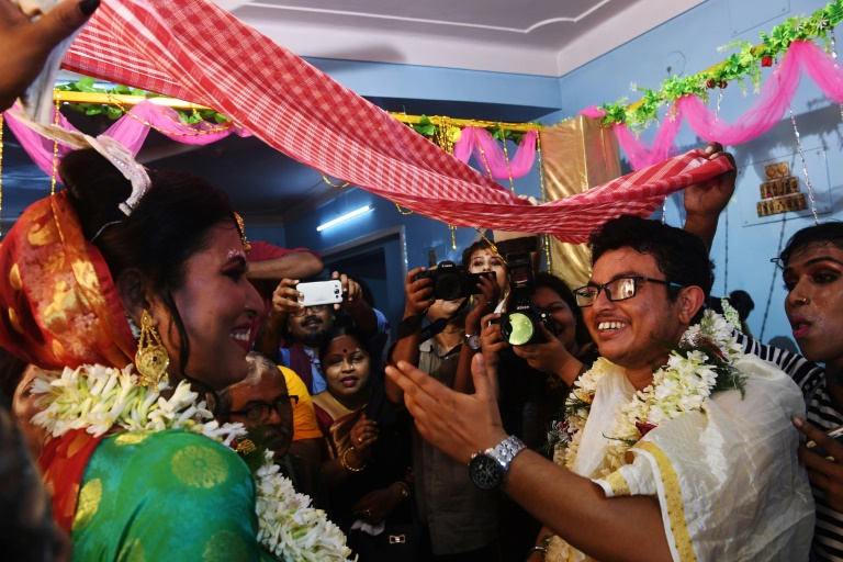 Indian transgender woman Tista Das (L), 38, and transgender man Dipan Chakravarthy, 40, perform the rituals of a traditional Hindu marriage ceremony, pledging their love for each other before family and friends, in Kolkata. — AFP