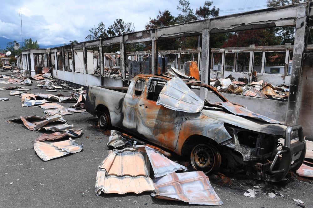 A car burned in September's riot is pictured at damaged office building of Jayawijaya's regent in Wamena, Papua, Indonesia, October 9, 2019 in this photo taken by Antara Foto. - Reuters