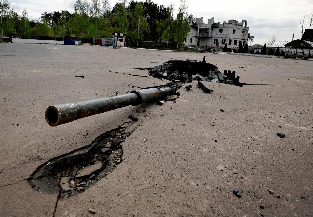 A destroyed Russian tank’s turret is seen stuck in the ground, amid Russian invasion of Ukraine in Zalissia, Kyiv region. - REUTERSpix