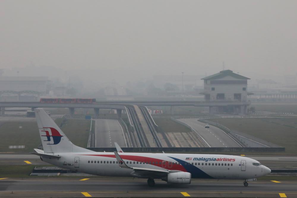 A Malaysia Airlines airplane is pictured on the haze-shrouded tarmac at Kuala Lumpur International Airport in Sepang, Malaysia, September 18, 2019. - Reuters