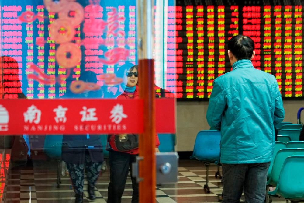 A man enters a stock brokerage office of Nanjing Securities in Nanjing, Jiangsu province, China-REUTERS PIX