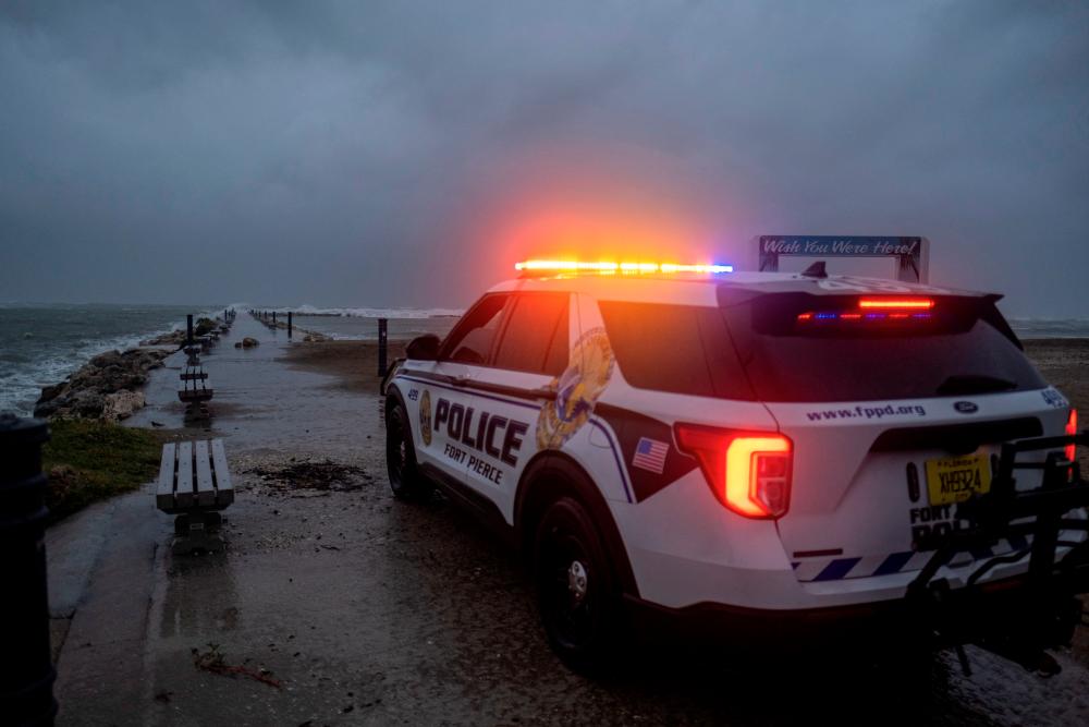 A police car blocks the entrance to the Inlet State Park before the expected arrival of Hurricane Nicole in Fort Pierce, Florida, U.S. November 9, 2022. REUTERSPIX