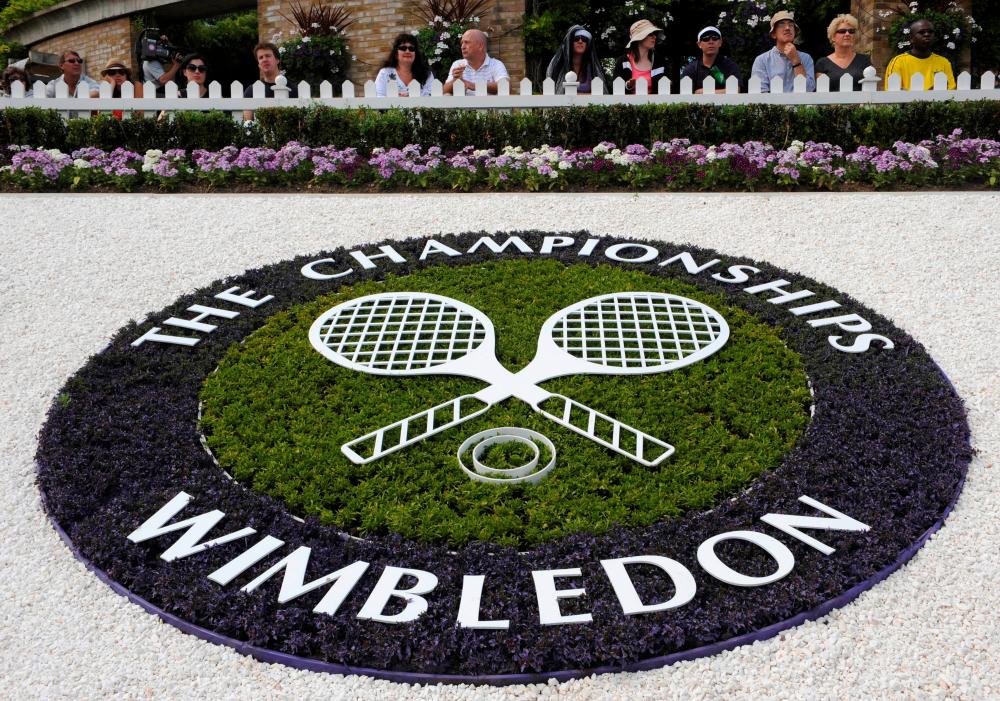 A Wimbledon logo is seen inside the grounds at the Wimbledon tennis championships in London June 23, 2008. - Reuters
