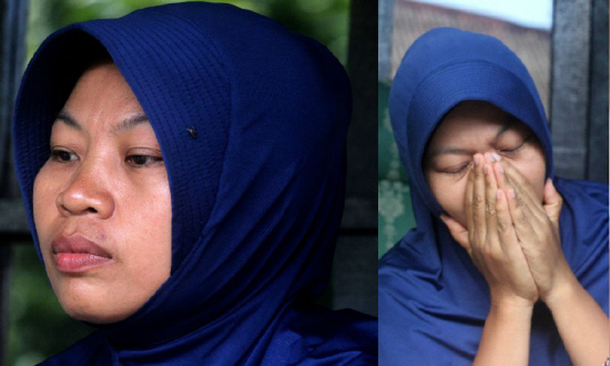 Baiq Nuril Maknun, who exposed her cheating boss, looks stunned after she got slapped with a six-month jail term for violating a controversial law against spreading indecent material, in Mataram on Lombok. - AFP