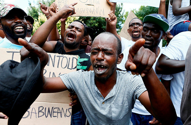 Protesters sing during a demonstration of Zimbabwean citizens outside the Zimbabwean Embassy in Pretoria on Jan 16, 2019, — AFP