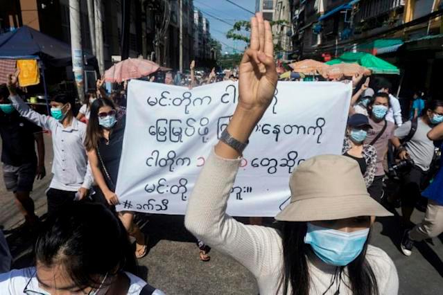 Anti-coup protesters flash a three-fingered salute in Myanmar. — AFP