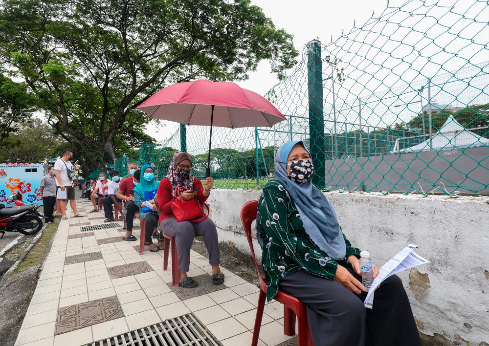 People wait to receive coronavirus disease (Covid-19) vaccines at mobile vaccination in Perumahan Awam Seri Johor Kuala Lumpur/ASYRAF RASID/THESUN