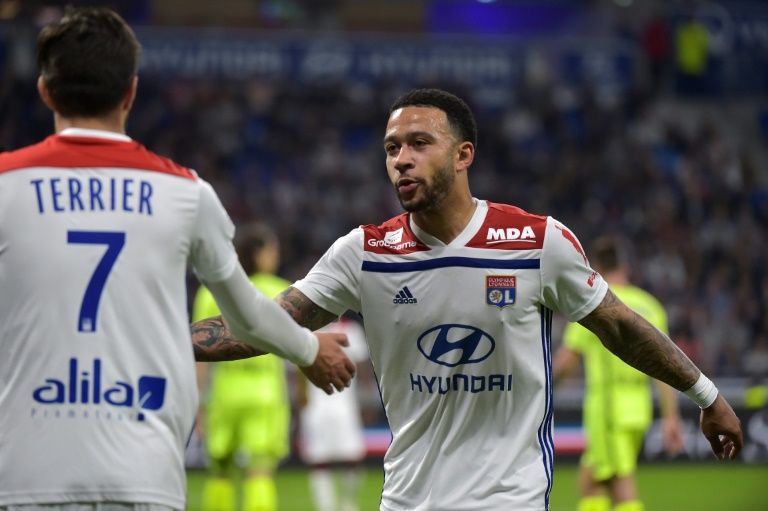 Lyon’s Dutch forward Memphis Depay (R) reacts with French midfielder Martin Terrier during the French L1 football match against Angers in Decines-Charpieu, near Lyon, central-eastern France. — AFP