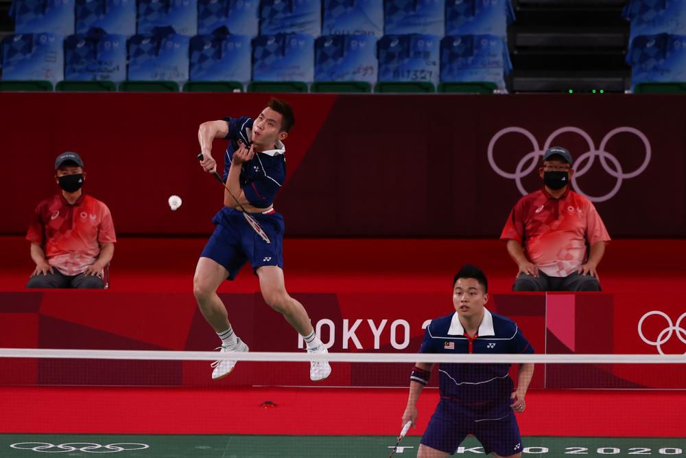 July 30, 2021, Aaron Chia of Malaysia and Soh Wooi Yik of Malaysia in action during the match against Li Junhui of China and Liu Yuchen of China. REUTERSPIX
