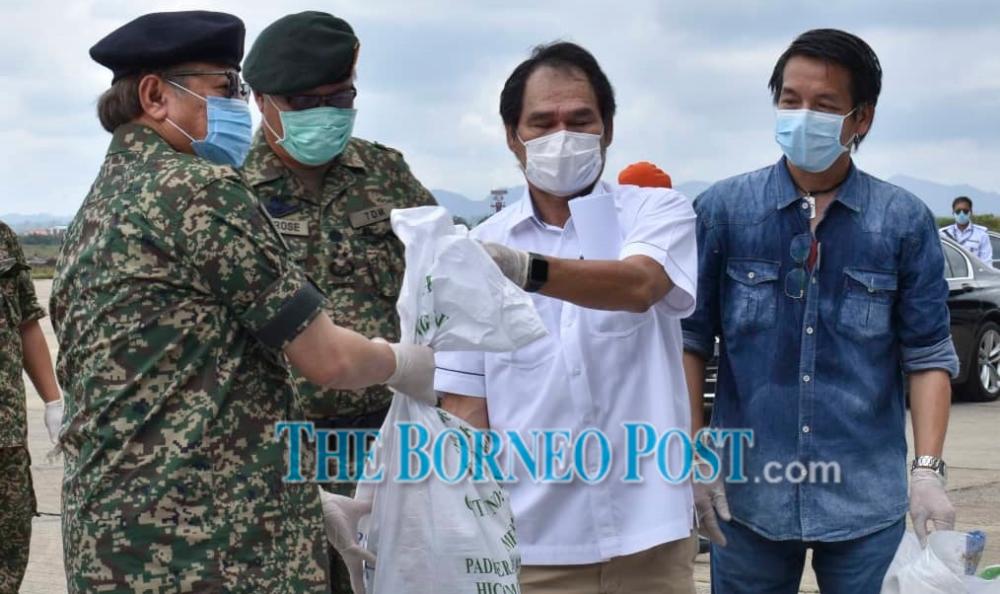 Abang Johari hands over the food assistance to Baram MP Anyi Ngau.