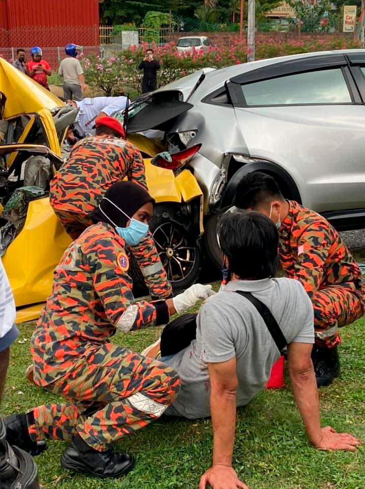 $!The Myvi driver was able to crawl out of his crushed vehicle and later taken to hospital for treatment. – Twitter