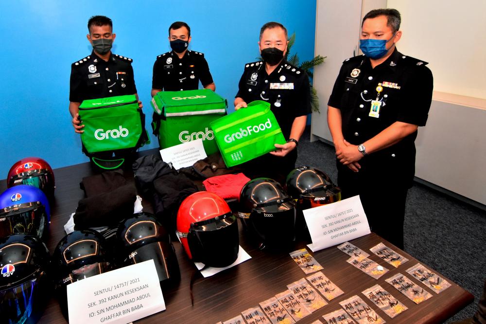 Beh showing equipment and helmets used by the suspects during a press conference at Sentul police headquarters yesterday. BERNAMApix