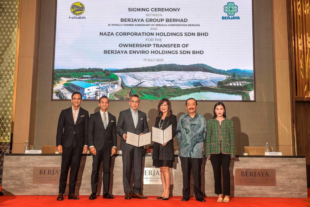 From left: Naza Corp deputy group chairman SM Faliq SM Nasimuddin, Naza Corp group executive chairman SM Nasarudin SM Nasimuddin, Ismee Ismail, Vivienne Cheng, Berjaya Corp founder and adviser Tan Sri Vincent Tan Chee Yioun and Berjaya Corp ED Chryseis Tan Sheik Ling at the signing ceremony. - Sunpix by Adib Rawi Yahya