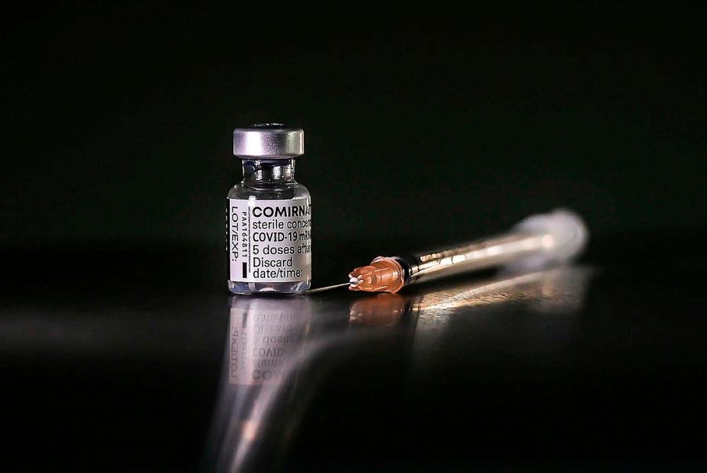 $!A vial of the Pfizer-BioNTech Covid-19 vaccine and a single use syringe arranged at the University Hospital in Sungai Buloh, Selangor, Malaysia, on Tuesday, March 2, 2021. The first phase of the vaccine roll-out that will run through April involves about 500,000 frontliners comprising health-care, defense and security personnel, as well as teachers with co-morbidities, according to the government. - ADIB RAWI YAHYA/THESUN
