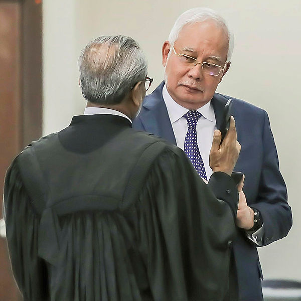 Former prime minister Datuk Seri Najib Abdul Razak and his lawyer Tan Sri Muhammad Shafee Abdullah while at the trial of the SRC International case in the Kuala Lumpur Courts Complex. — Sunpix by Adib Rawi Yahya