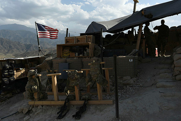 US Army soldiers from Nato looks on as US flag flies in a checkpoint during a patrol against Islamic State militants at the Deh Bala district in the eastern province of Nangarhar Province. — AFP