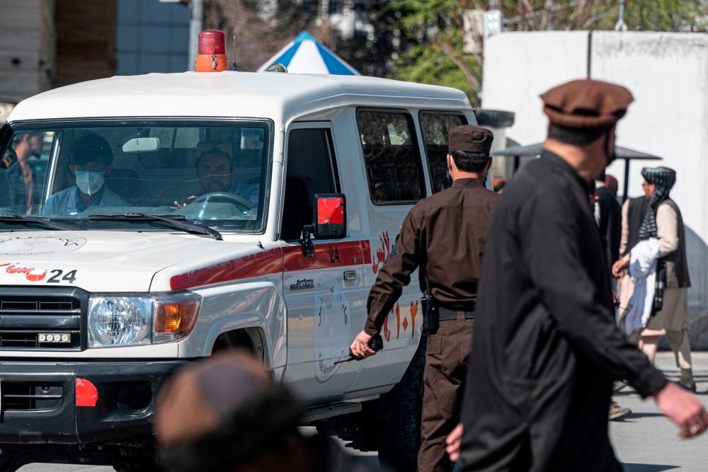 An ambulance carries victims from near the site of a suicide attack in Kabul on March 27, 2023. AFPPIX