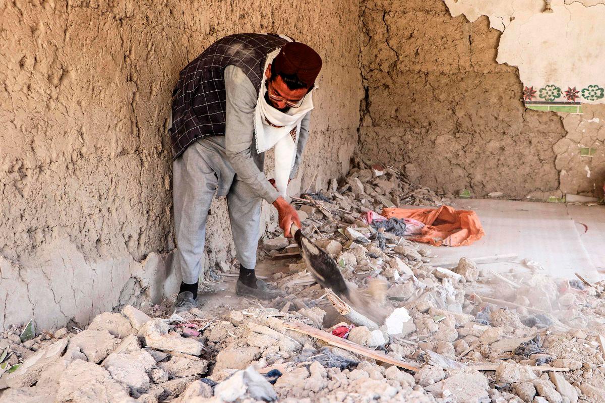 An Afghan resident clears the remains of a damaged house in the aftermath of aerial strikes by Pakistan in Urgun district at Paktika province on October 18, 2025. - AFPpix