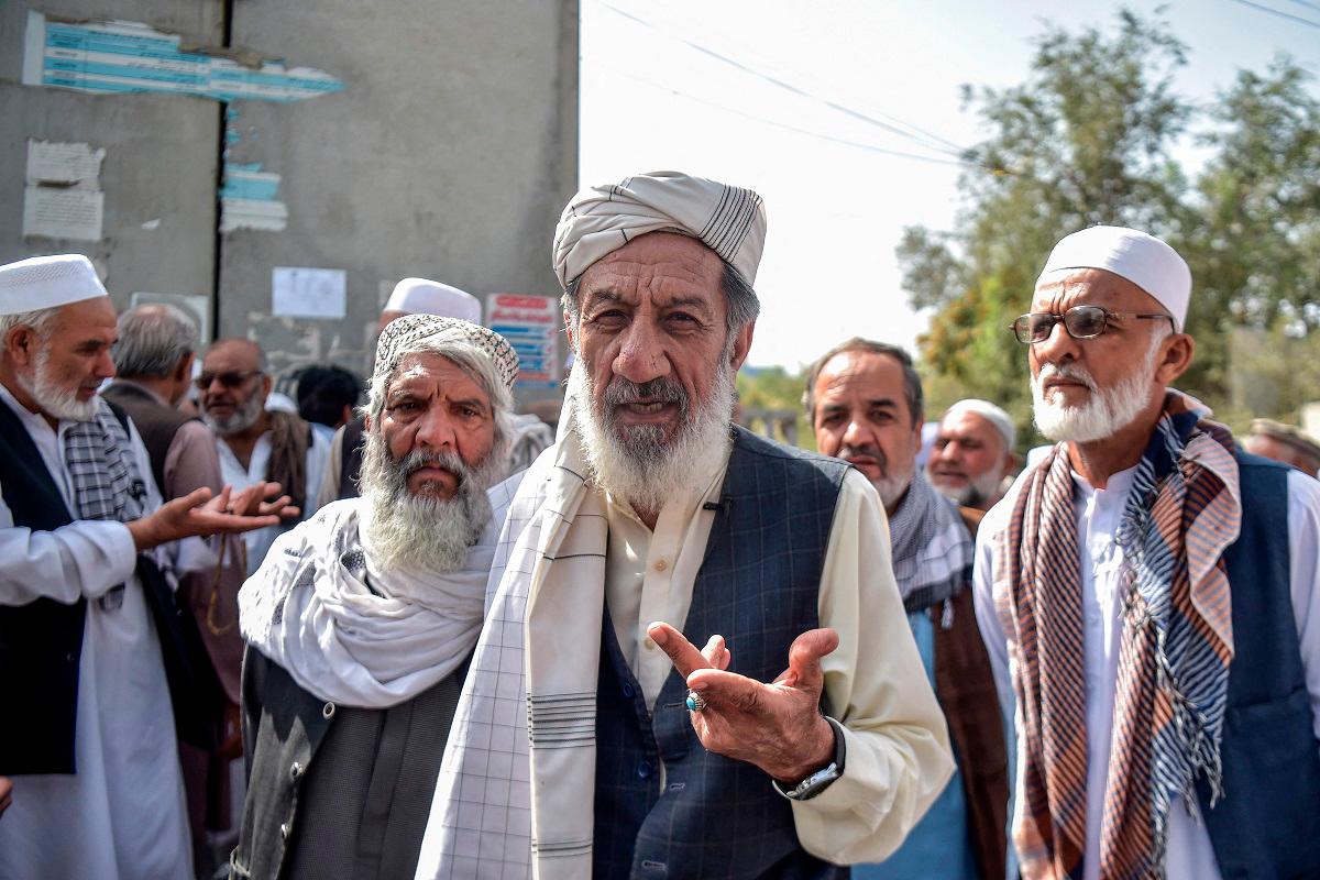 In this photograph taken on August 25, 2025, an Afghan retiree, Abdul Sabir (C), speaks during an interview with AFP outside a government building in Kabul. - Bais Yusufi / AFP