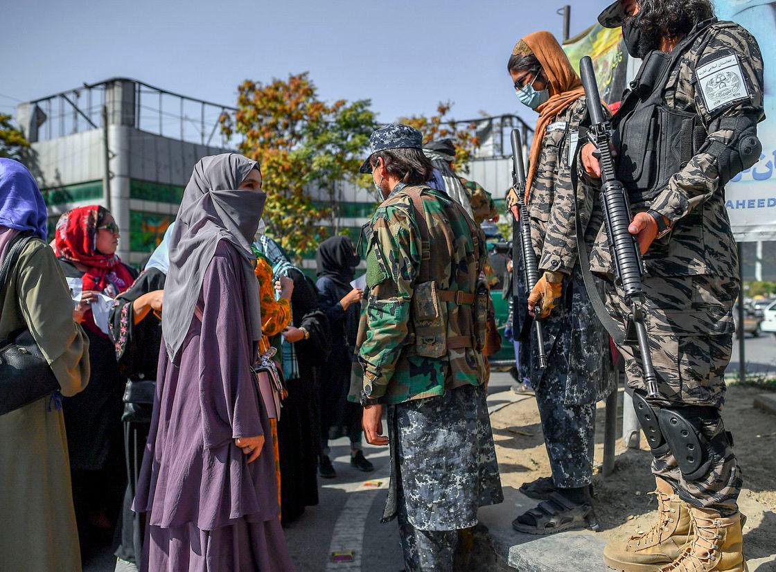 Taliban members stop women protesting for women’s rights in Kabul on October 21, 2021. Photo by AFP