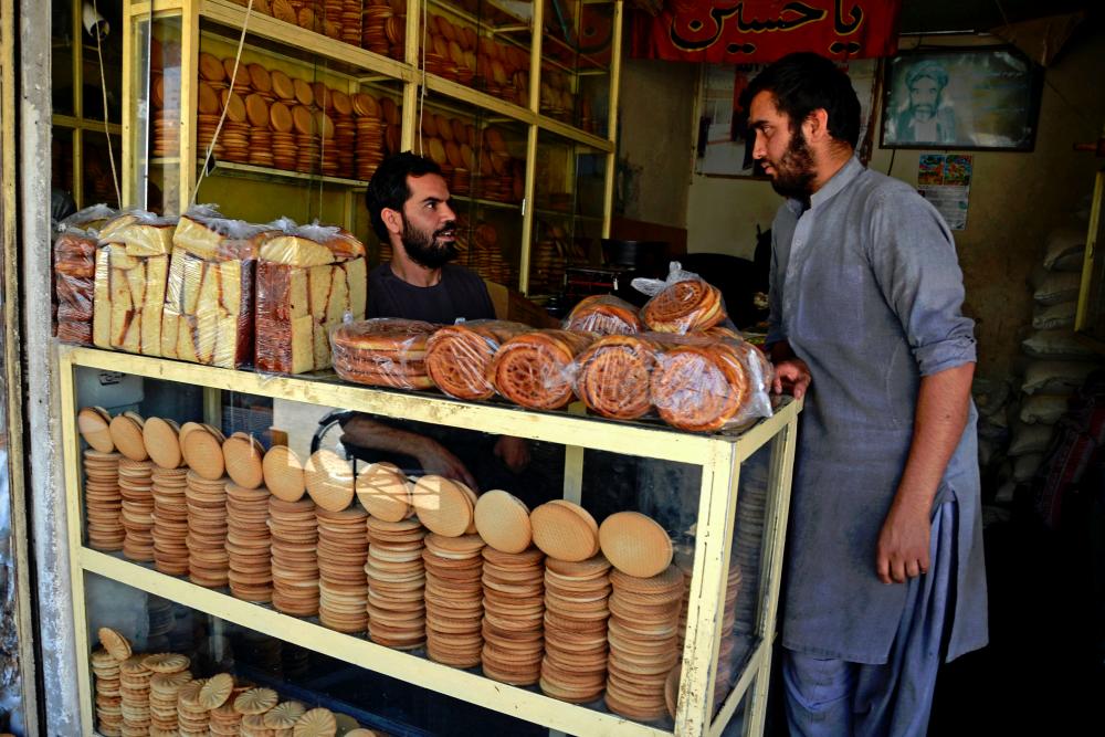 Shopkeepers selling cakes wait for customers ahead of the Eid al-Fitr, which marks the end of the Muslim’s holy fasting month of Ramadan at a bakery in Kandahar. - AFPpix