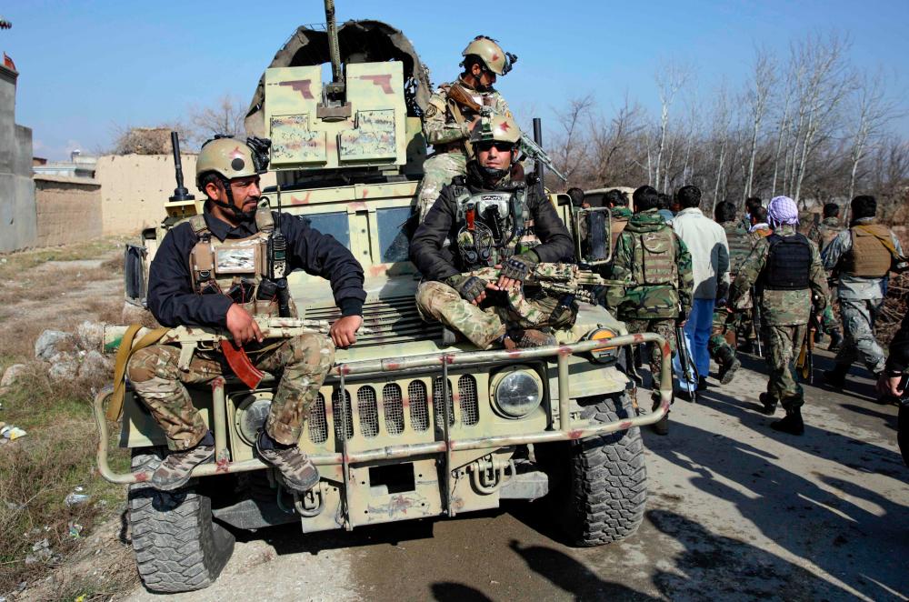 Afghan security forces arrive at the site of a car bombing near the largest US military in Afghanistan, north of Kabul in Parwan province, on December 11, 2019. - AFP