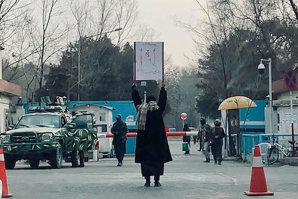 This picture taken on December 25, 2022 shows student Marwa protesting alone against the ban on women’s higher education, outside the Kabul University as members of Taliban stand guard in Kabul. AFPPIX